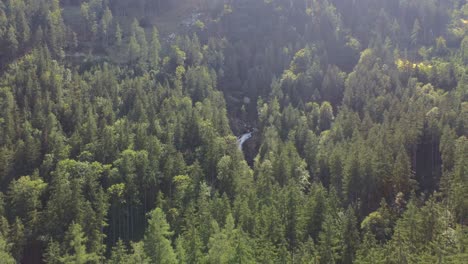 Gollinger-waterfall-and-wild-forest-aerial-view,-Austria,-dolly-out,-day