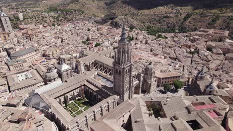 High-angle-arcing-view-over-Toledo-cathedral,-iconic-architectural-Gothic-marvel