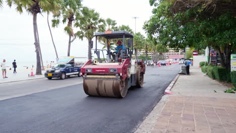 Laying-a-renewed-asphalt-by-paver-and-compaction-new-asphalt-pavement-with-road-rollers-on-Beach-Road-in-Pattaya-City,-Thailand