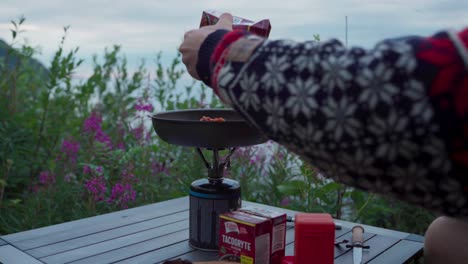 Camper-Cooking-Food-Outdoor-At-Sunset-In-Sifjord,-Senja,-Norway