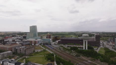 Aerial-View-Of-Hyllie-Water-Tower,-Malmo-Arena,-And-Malmo-Hyliie-Station-On-A-Cloudy-Day-In-Sweden