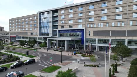 Low-aerial-view-of-entrance-to-Saint-Joseph-Hospital-in-City-Park-West,-Denver