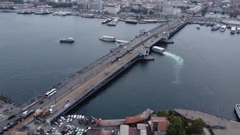 Aerial-drone-footage-of-stunning-galata-bridge-in-istanbul-with,-bosphorus,-ships-and-ferries-in-the-background