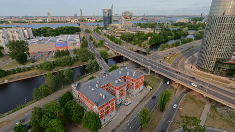 -Aerial-View-of-Vanšu-Bridge-Amidst-City-Traffic-and-Architectural-Landscape-in-the-Foreground