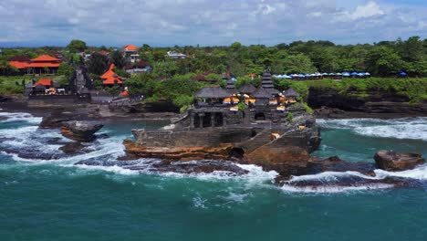 Famous-Tanah-Lot-Temple-In-The-Sea-In-Bali,-Indonesia---aerial-drone-shot