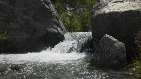 Small-waterfall-between-rocks-on-sunny-day-in-summer-season