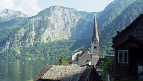 Establishing-shot-of-peaceful-scenery-with-view-of-Hallstatt-church,-Austria