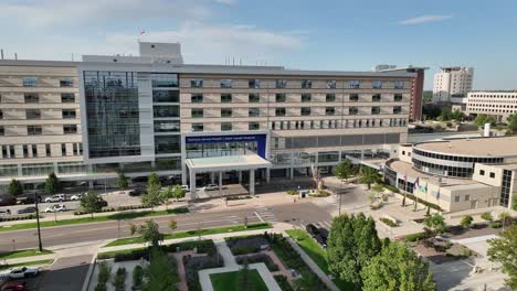 Aerial-arc-establisher-shot-of-Saint-Joseph-Hospital-in-City-Park-West,-Denver