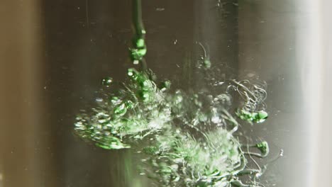 Liquid-dish-soap-falling-in-water-in-slow-motion