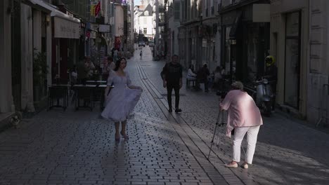 Photo-shooting-of-a-female-model-dressed-as-a-princess-in-a-pedestrian-street-of-Pau,-,-capital-of-Pyrénées-Atlantiques,-South-West-department-of-France