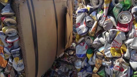 Panning-close-up-view-of-bales-of-aluminum-cans-compacted-for-recycling