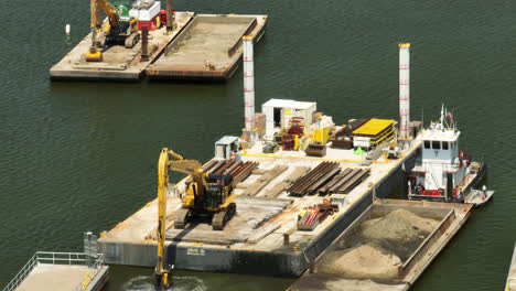 Excavator-Removing-sand-dredging-the-Mississippi-River,-telephoto-shot