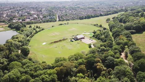 Overhead-view-of-Alexandra-Park-football-club,-residential-area-in-background