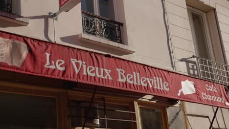A-warm-sun-illuminates-the-awning-of-the-Vieux-Belleville-restaurant-in-Paris,-France