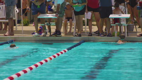 Young-Male-Swimmers-Racing-To-The-Finish-Line-In-The-Pool