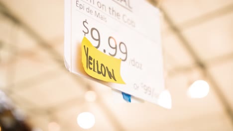 A-Hanging-Sign-at-a-Vegan-Organic-Summer-Farmers-Yellow-Market-Reads-Local-Seeded-Watermelon-is-on-Sale-in-St-Léon-Gardens-Winnipeg-Manitoba-Canada