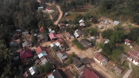 Top-down-view-of-remote-village-Muang-ngoy-during-day-time,-aerial