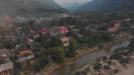 Wide-shot-of-Muang-ngoy-small-village-at-Laos,-aerial