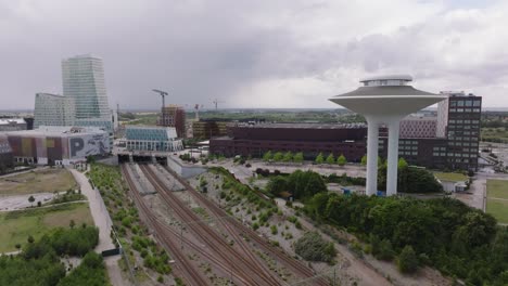 Cloudy-Sky-Over-District-Of-Hyllie-In-Malmo,-Sweden-With-Hyllie-Water-Tower,-Malmo-Arena,-Railroads,-And-Hotel-Building-In-View