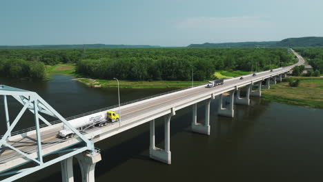 Semi-trailer-Trucks-Driving-Through-The-Wabasha-Nelson-Bridge-Crossing-The-Mississippi-River