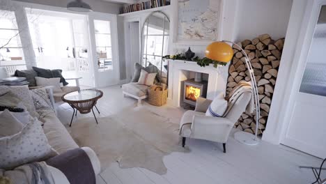 stove-in-white-lounge-next-to-wood-pile