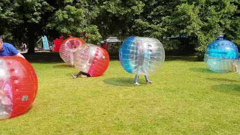 Kids-in-huge-Bubble-Soccer-Ball-struggle-to-stand-up-Outdoor-Inflatable-Games