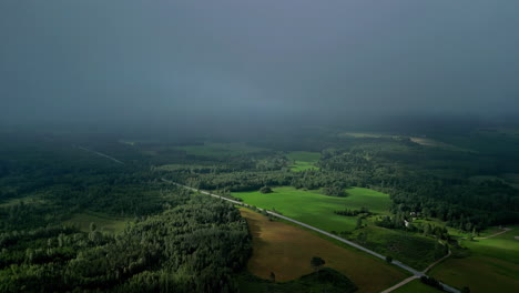 Aerial-drone-establishing-shot-of-a-gray-foggy-countryside-landscape