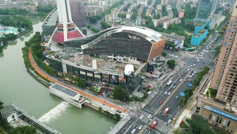 Cinematic-Zoom-and-descending-drone-footage-of-339-shopping-mall-in-China,-Chengdu,-during-busy-day-and-traffic