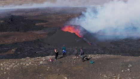 Adventure-hikers-enjoying-magical-view-of-an-erupting-volcano-in-Iceland