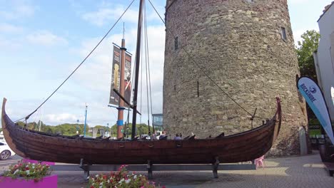 Waterford-City-Centre-Replica-Longboat-outside-Reginald's-Tower-on-a-summer-morning