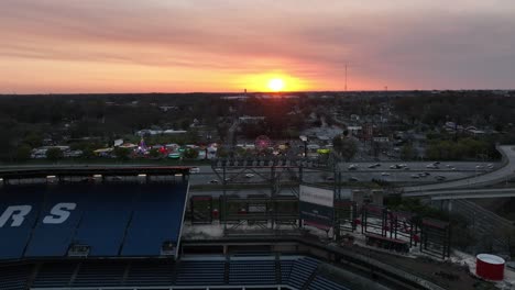 Atlanta-near-the-Center-Parc-Stadium,-Downtown-Connector-freeway-with-moving-traffic-at-sunset,-Aerial-View