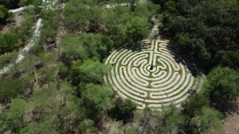 Aerial-establishing-shot-of-a-geometrical-stone-maze-puzzle-in-the-countryside