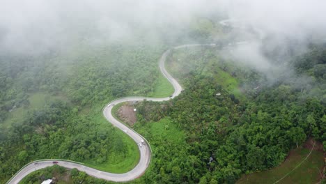Blanket-of-fog-coming-down-over-vehicles-travelling-through-Phetchabun,-Thailand