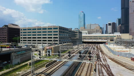 Drone-shot-following-a-AMTRAK-train,-arriving-in-downtown-Chicago,-Illinois,-USA