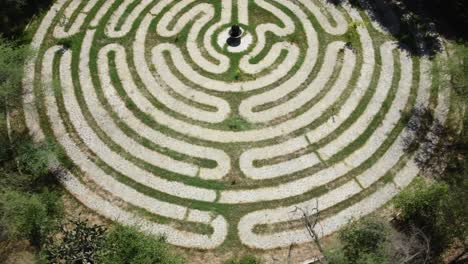 Aerial-rising-shot-of-a-maze-walkway-with-a-stone-pathway-exhibit