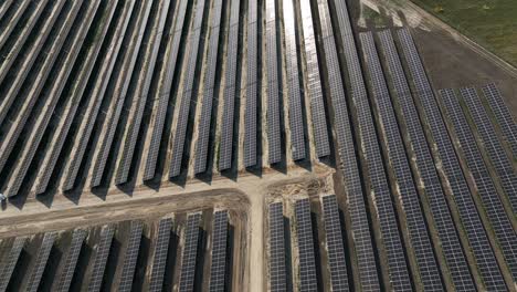 drone-aerial-top-down-sunny-bright-day-reflection-on-solar-panel-farm-station