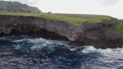 Waves-crashing-against-the-cliff,-drone-shot