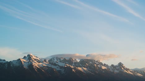 Timelapse-of-snow-covered-mountains-at-sunrise-with-clouds