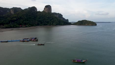 Long-Tail-Boat,-departing-from-Dock-in-Krabi-Thailand--aerial-perspective