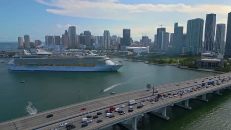 Beautiful-aerial-over-MacArthur-Causeway-Bridge-to-huge-cruise-ship