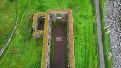 Aerial-zenithal-shot-of-a-drone-descending-inside-a-Medieval-Cathedral-in-ruins