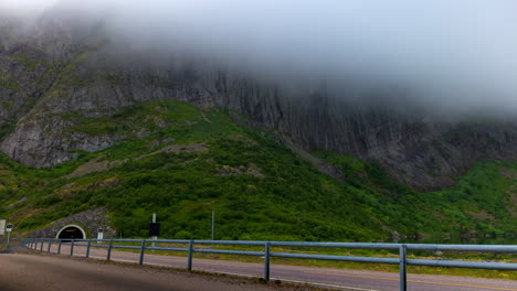 Vehicles-Driving-Through-Road-Tunnel-In-Rocky-Mountain-Covered-With-Fog-In-Norway