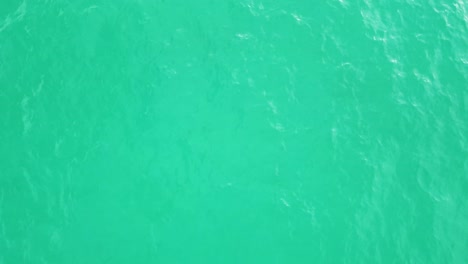 Turquoise-green,-blue-water-surface-seen-from-top