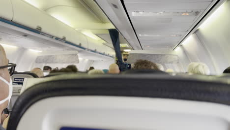 Passenger-Point-of-View-of-WestJet-Flight-Attendant-Showing-Passengers-Safety-Procedures-Information-Card-on-WestJet-Airplane-at-LAX-Airport-on-7-13-2023