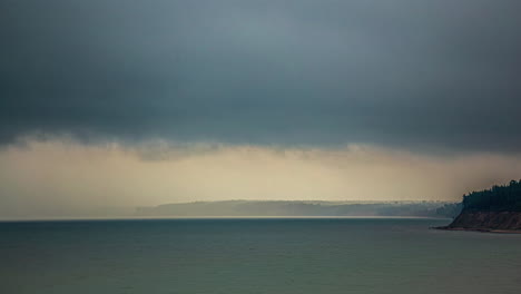 Storm-Clouds-Timelapse-with-Nimbostratus-Clouds-and-Rain-Falling-on-the-Ocean-Horizon