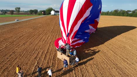 Men-and-Women-leaving-basket-of-hot-air-balloon-after-journey-trip-in-the-air-above-american-countryside