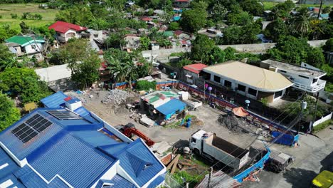 Aerial-dolly-of-small-building-construction-site-in-a-rural-community-town-of-Legazpi,-Albay