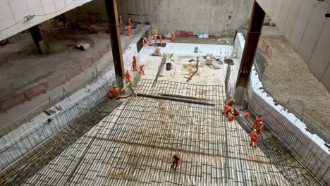 Looking-Down-At-Concrete-Foundation-Works-With-Rows-Rebar-Along-Ground-With-Workers-At-Old-Oak-Common-High-Speed-Rail-Construction-Site