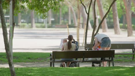 Two-mothers-taking-a-break-with-their-babies-in-the-park