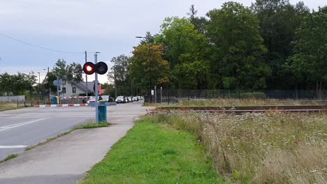 Operail-transportation-train-passes-by-while-the-road-for-cars-have-been-closed-in-Europe-Estonia-Tartu